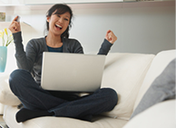 Woman celebrating with laptop