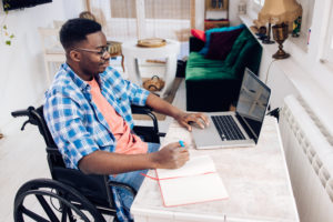 African American in a wheelchair freelancing from home