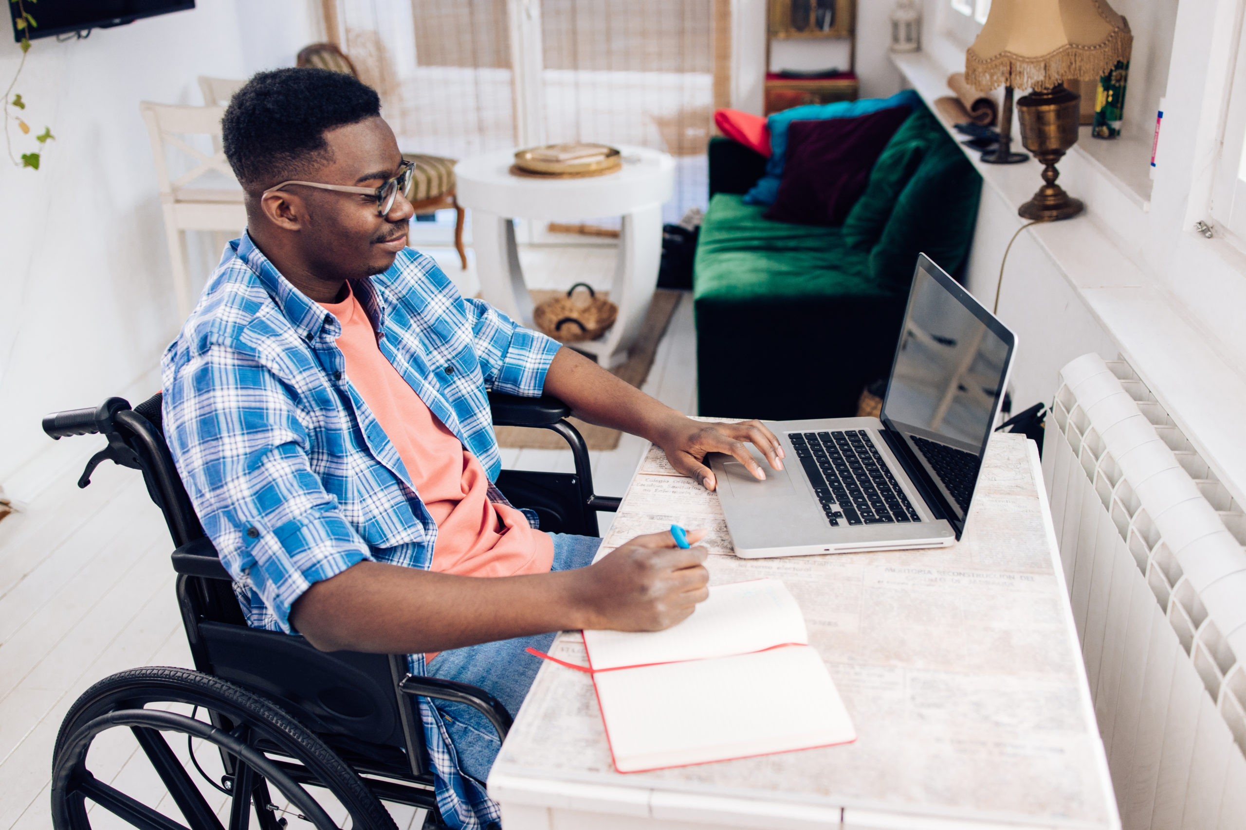 African American in a wheelchair freelancing from home