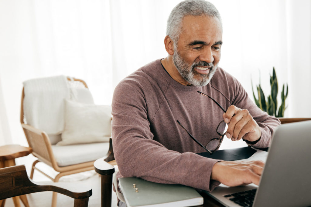 Senior men teaching online lesson